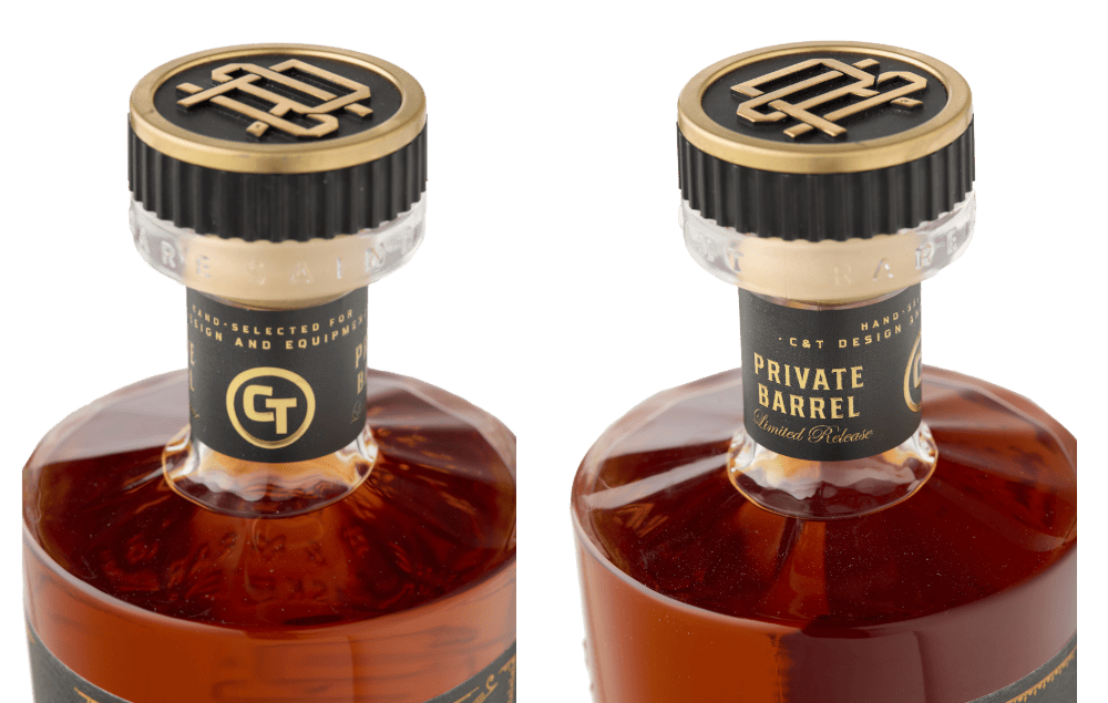 Close-up of Rare Saint bourbon bottle tops showing branded gold-and-black caps and neck labels.